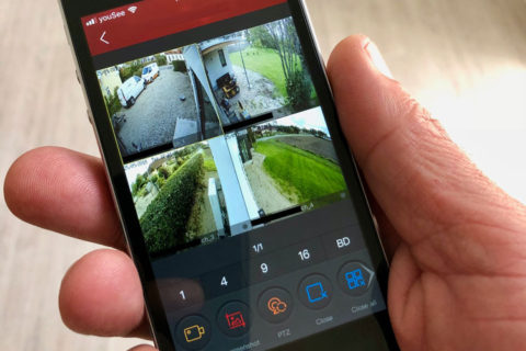Smartphone med billeder af videoovervågnings kameraer